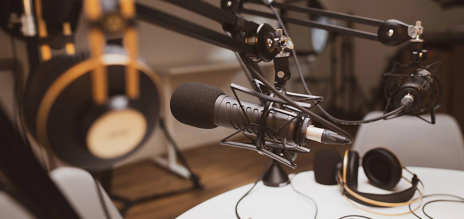 closeup of a microphone and headphones in a recording studio